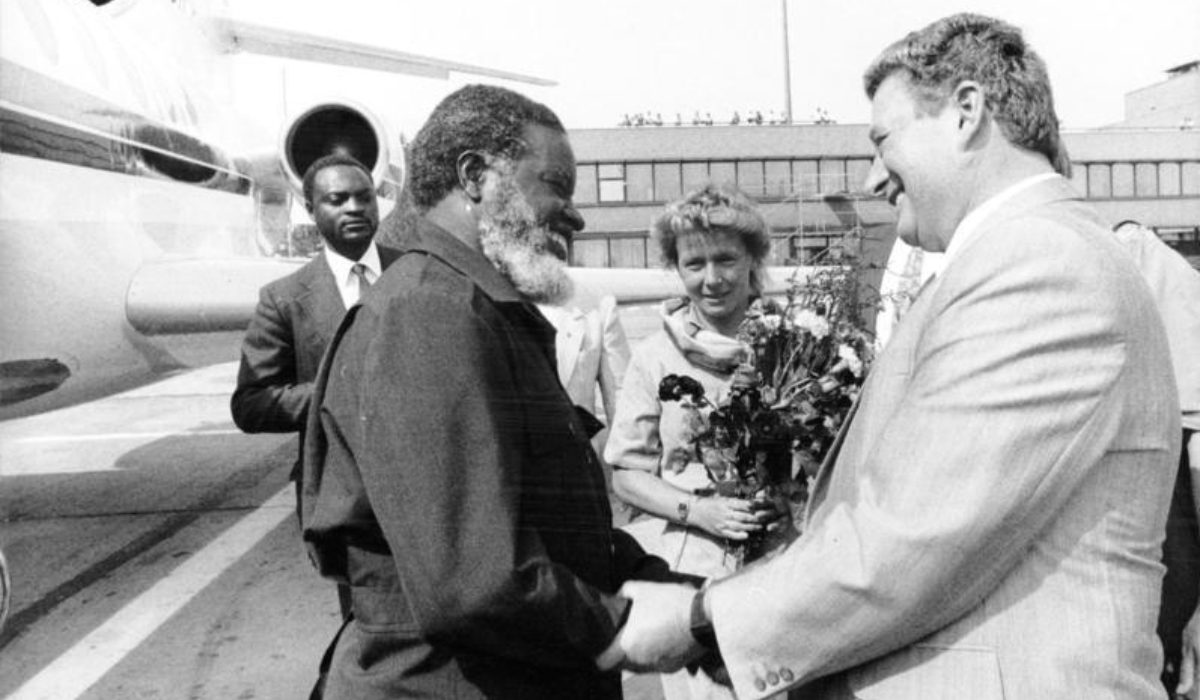 President of SWAPO, Sam Nujoma arrives in Berlin, Germany for working visit, welcomed by Günter Sieber, member of SED Central Committee and head of the International Relations Department, 1989