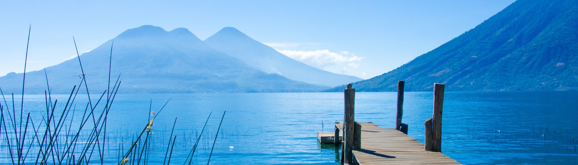 Dock and volcanoes at Lake Atitlan in Guatemala