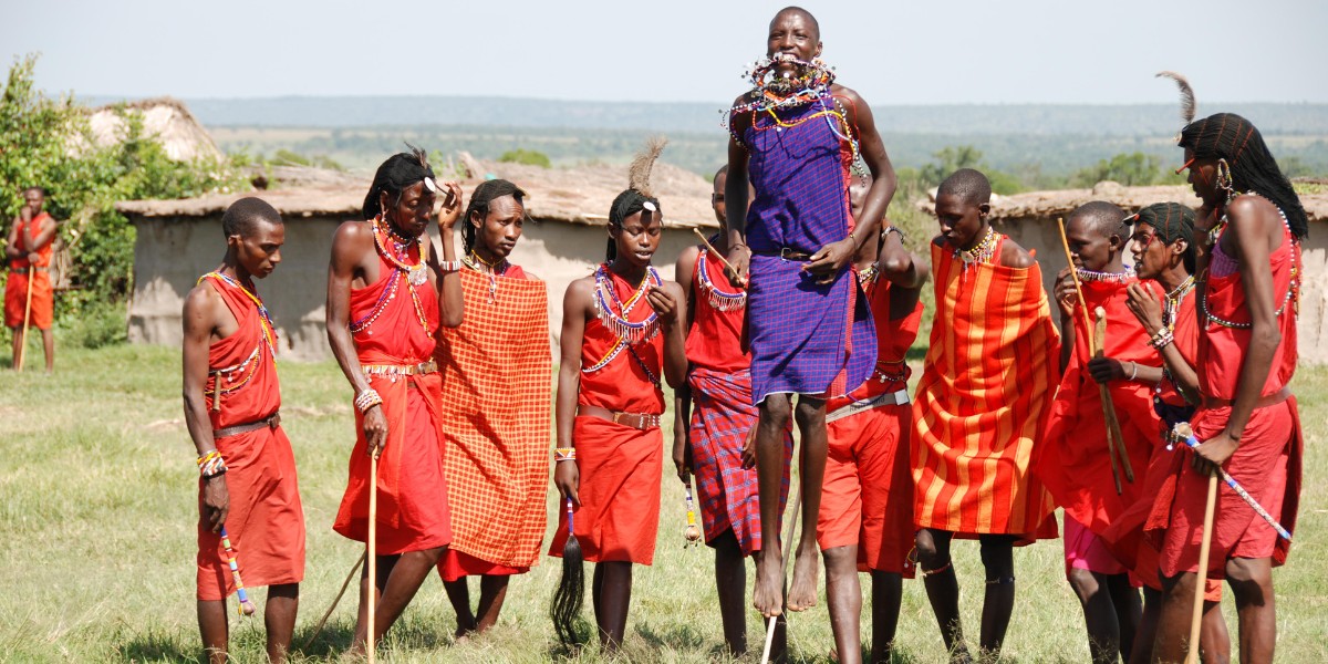 Maasai tribe ceremony and culture, people watching man jump
