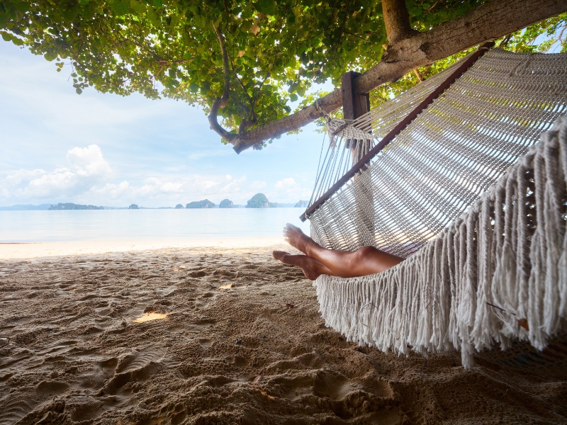 Luxury vacation lying in hammock on beach