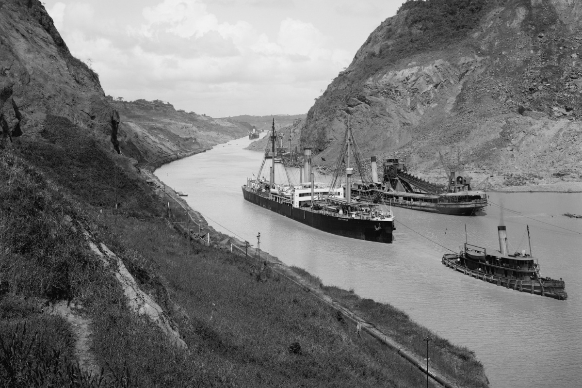 Three boats move through Panama Canal at the Culebra Cut (Gaillard Cut), crossing the continental divide circa 1910-14