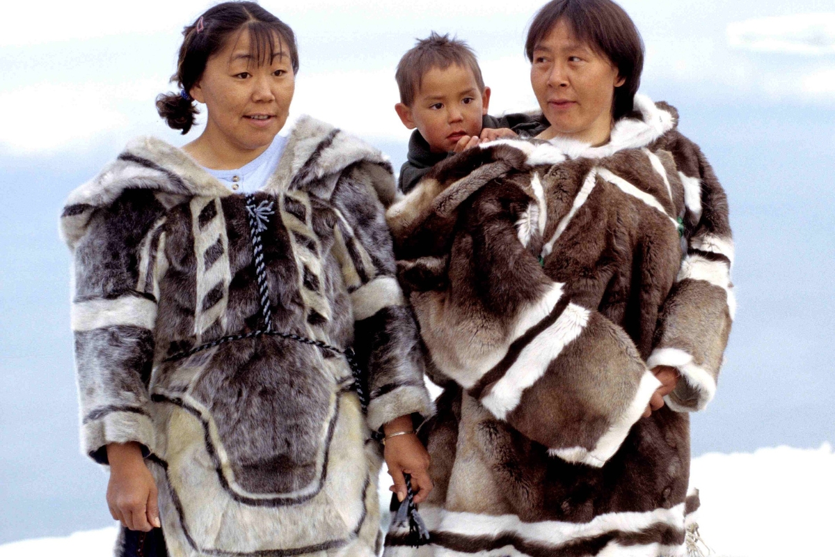 Inuit women and child wearing traditional clothing made of fur seal and caribou skin