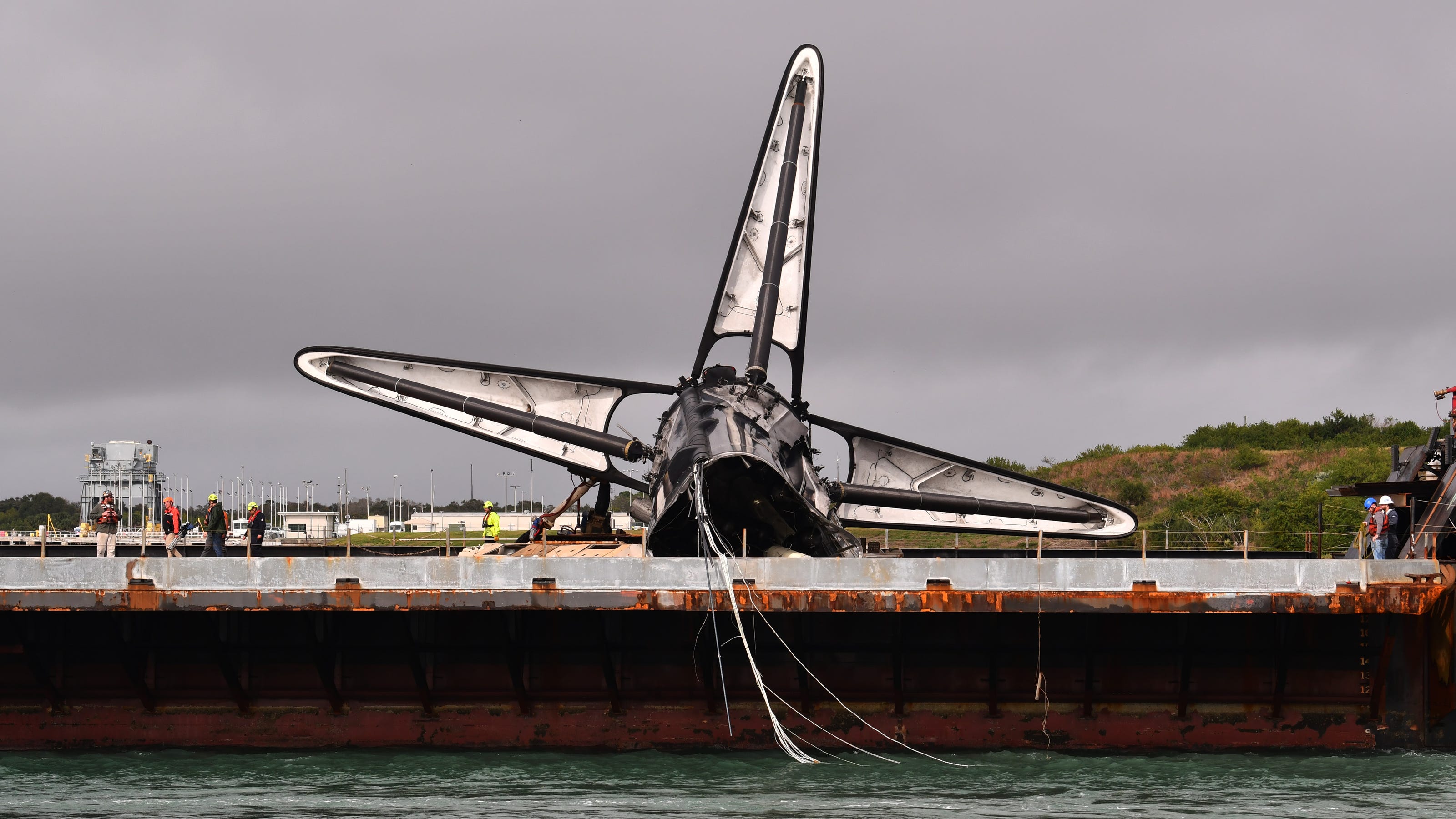 Bashed-up SpaceX Falcon 9 rocket booster returns to Port Canaveral