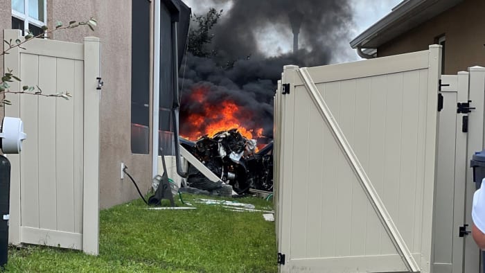 PHOTOS: Tesla bursts into flames after slamming into Florida home