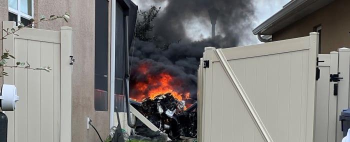 PHOTOS: Tesla bursts into flames after slamming into Florida home