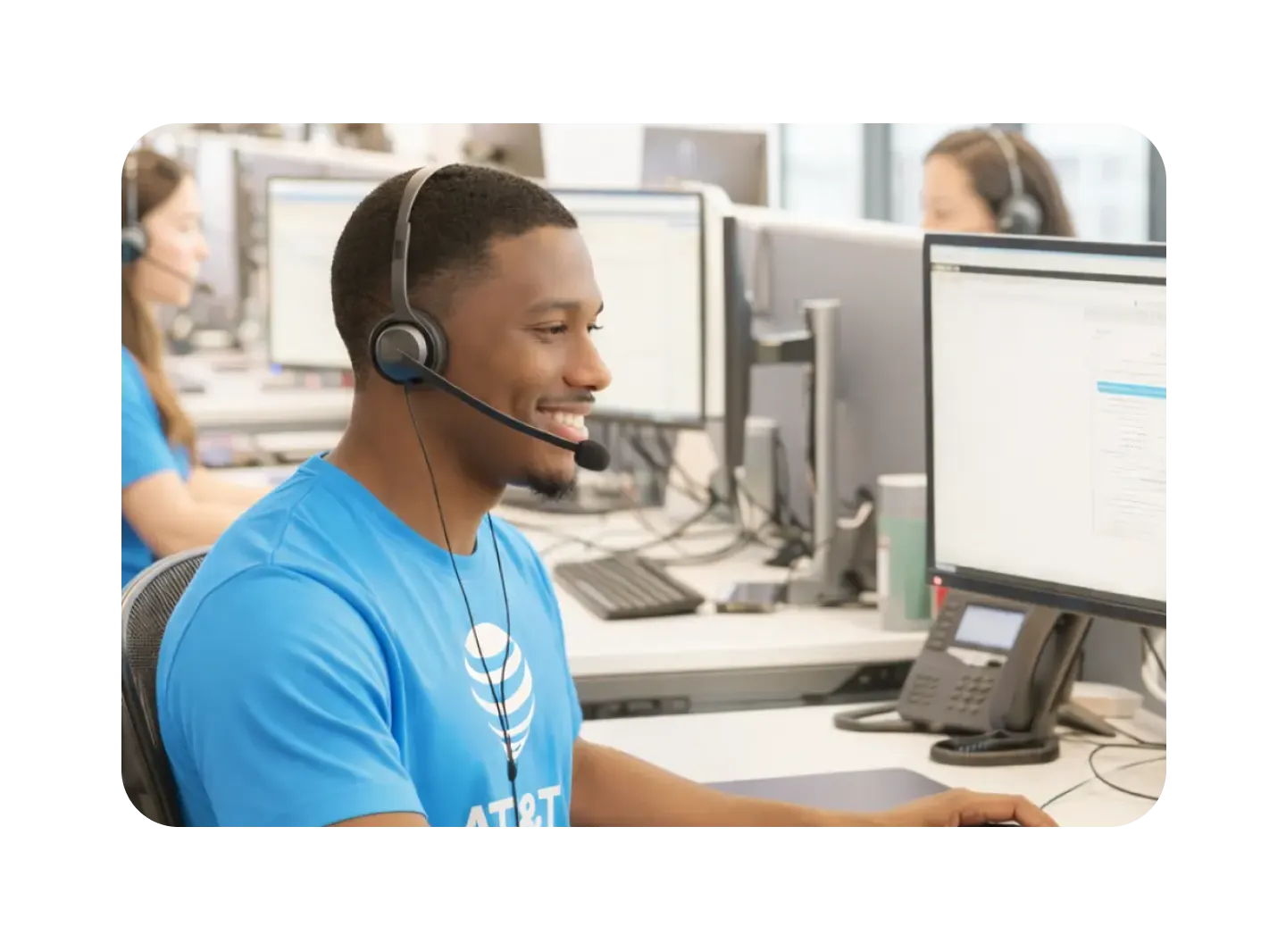 AT&T customer support representative assisting a customer at a computer, highlighting technical support, account assistance, and reliable customer service.