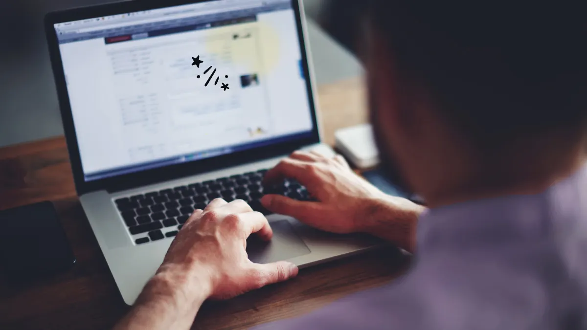 Man working on laptop that has yellow spot on screen.jpg