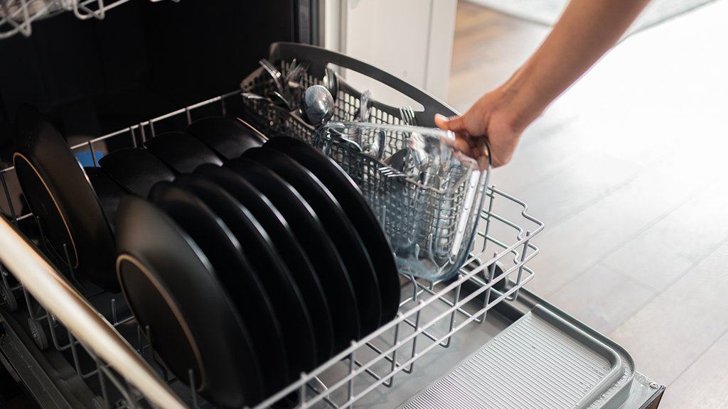Person loading dishes into a dishwasher