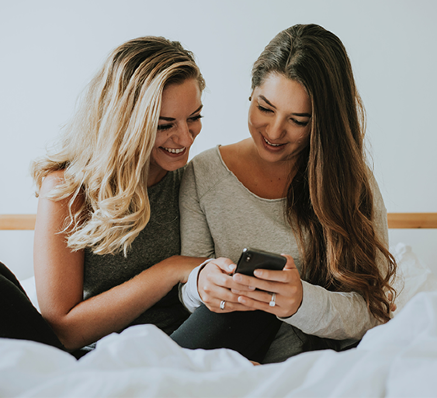 Two women looking at a smartphone