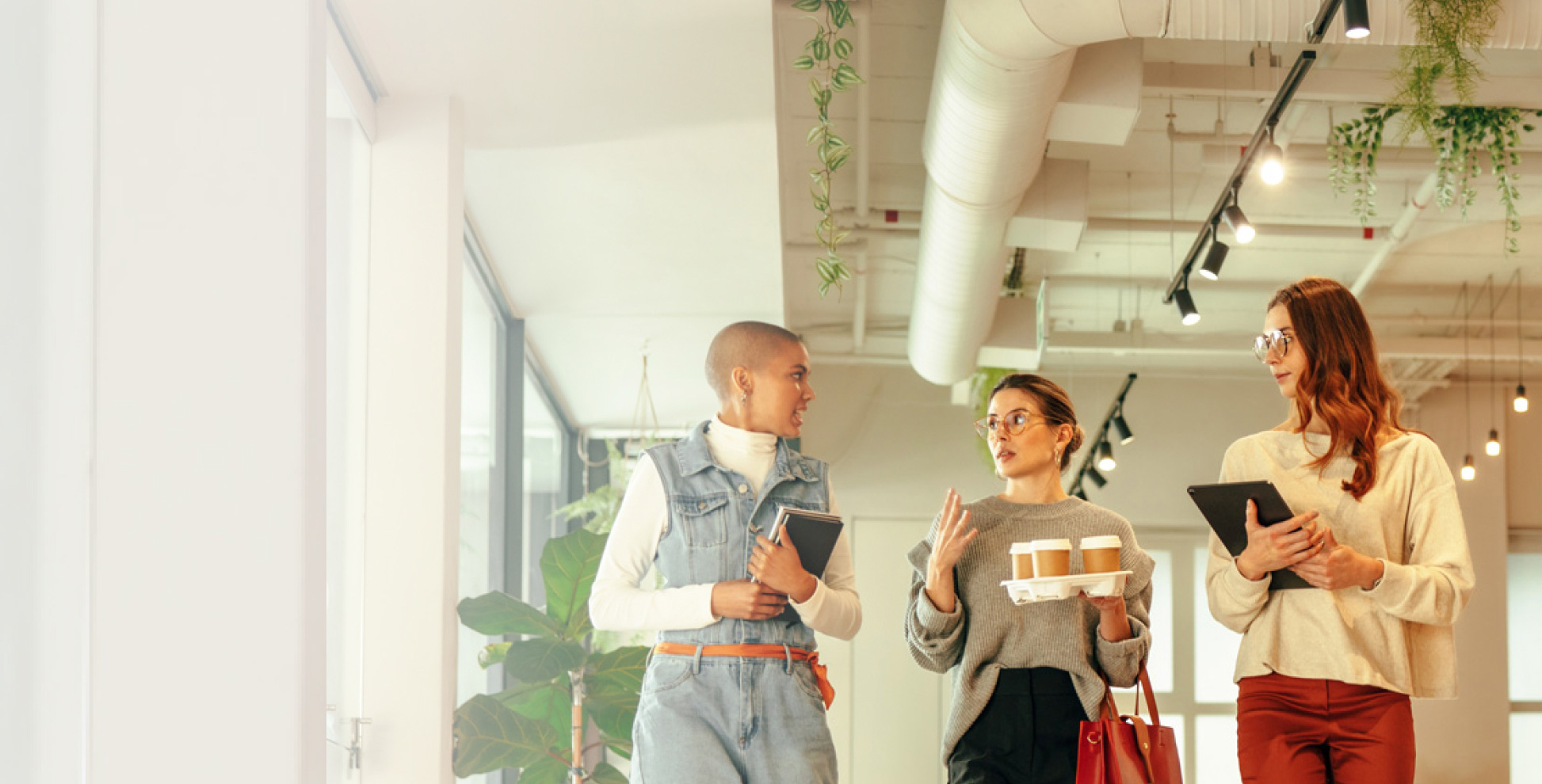 three women walking in office