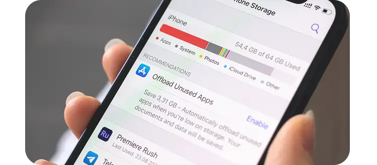 Close-up of iPhone storage settings showing app storage usage and recommendations to offload unused apps and free up space.