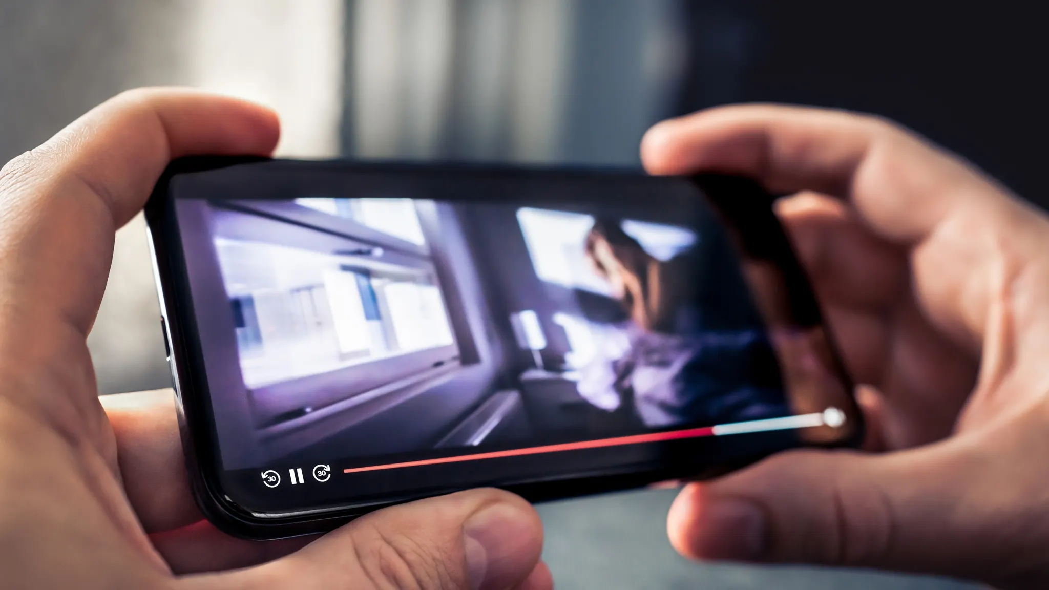 Person watching YouTube on phone, illustrating how to fix app issues on iPhone and Android devices