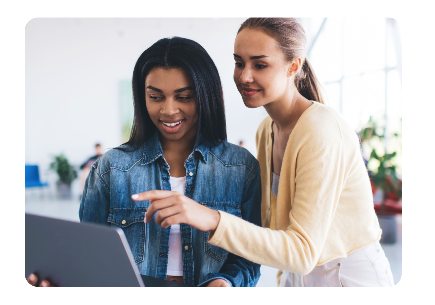 Two women using a laptop