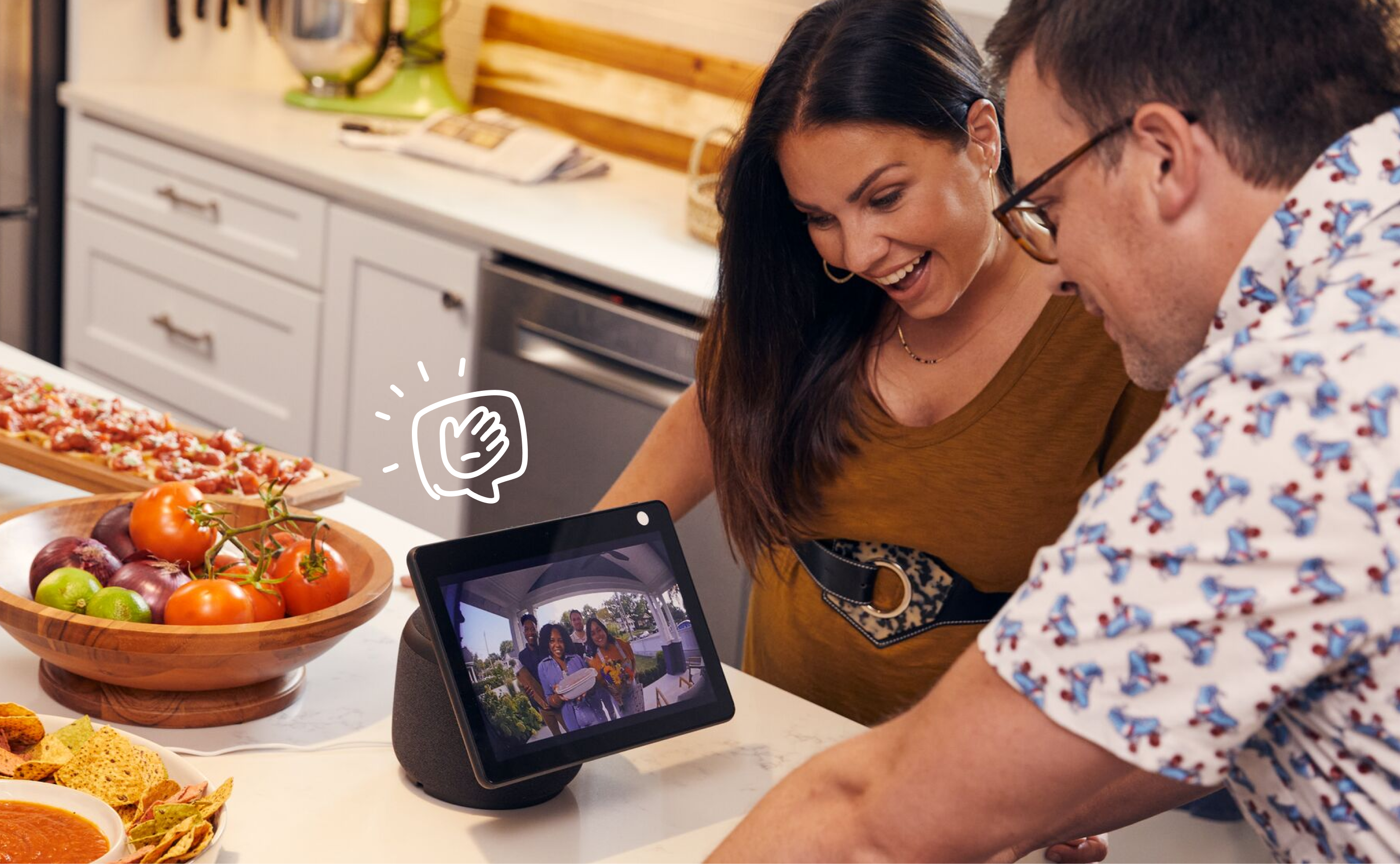 Couple viewing their smart home hub with screen in their kitchen
