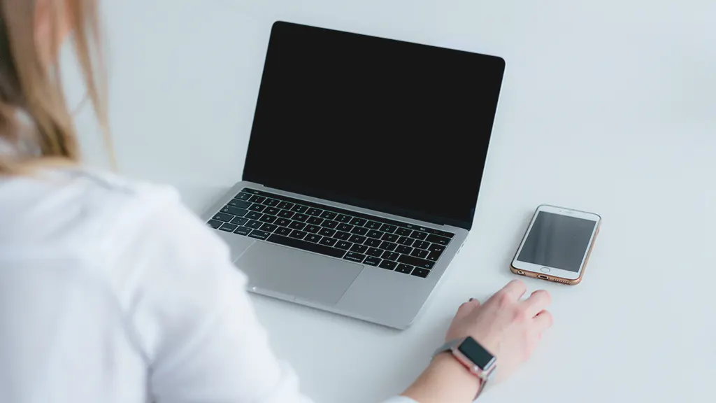 Woman with MacBook that's not powering on