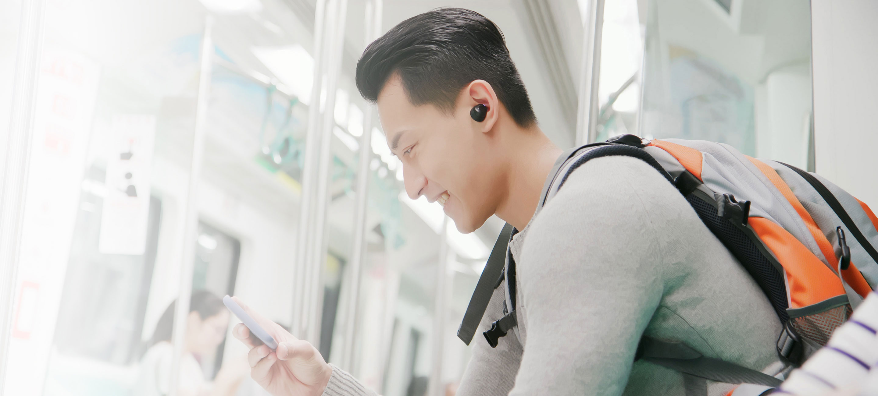 man wearing Samsung Galaxy Buds in subway