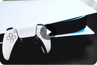 Sony PlayStation 5 console with DualSense controller on a dark surface.