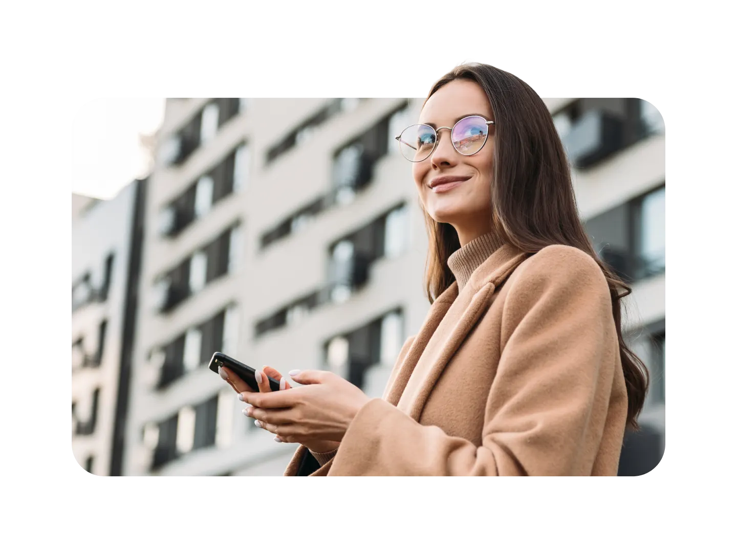 woman smiling holding phone