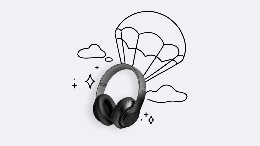 A pair of headphones floating through the air with a parachute attached