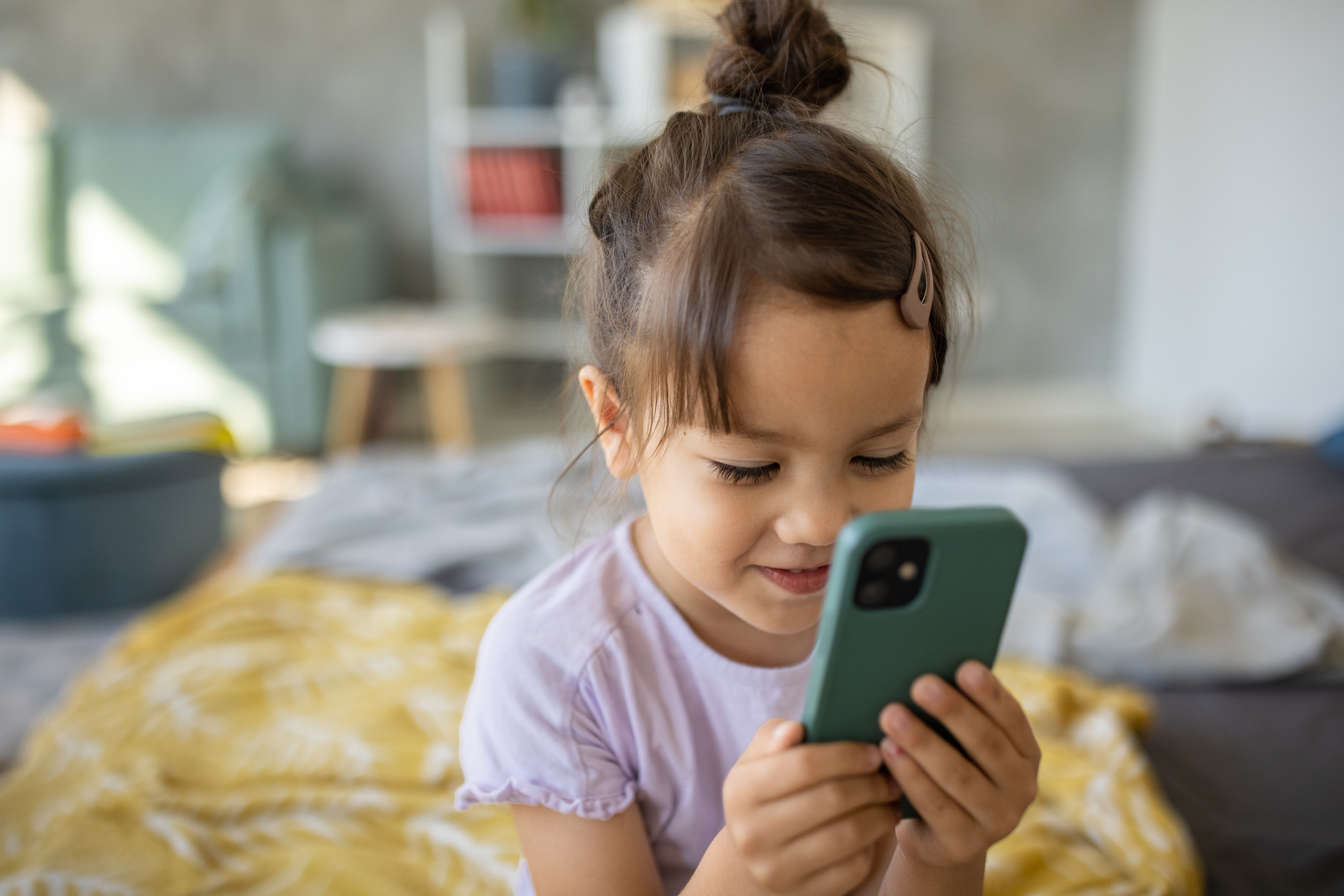 girl on bed on phone 