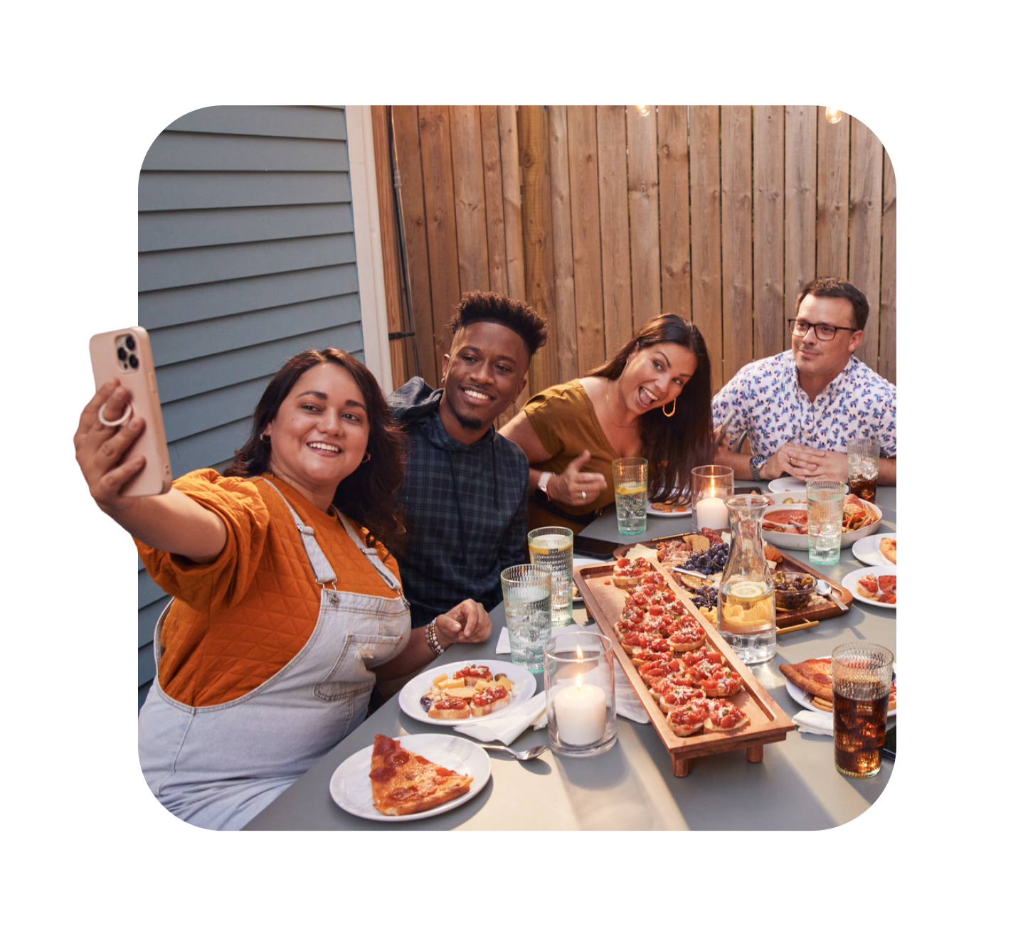 Friends taking selfie at an outdoor table