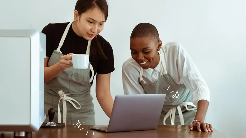 Two people using old computer in kitchen