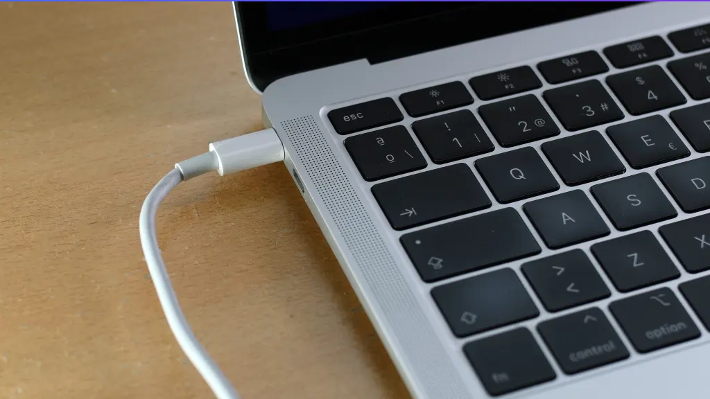 Close up of laptop charger jack with a white USB-C cord attached