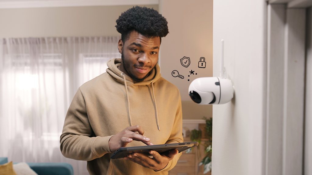 Man setting up smart camera in home securely