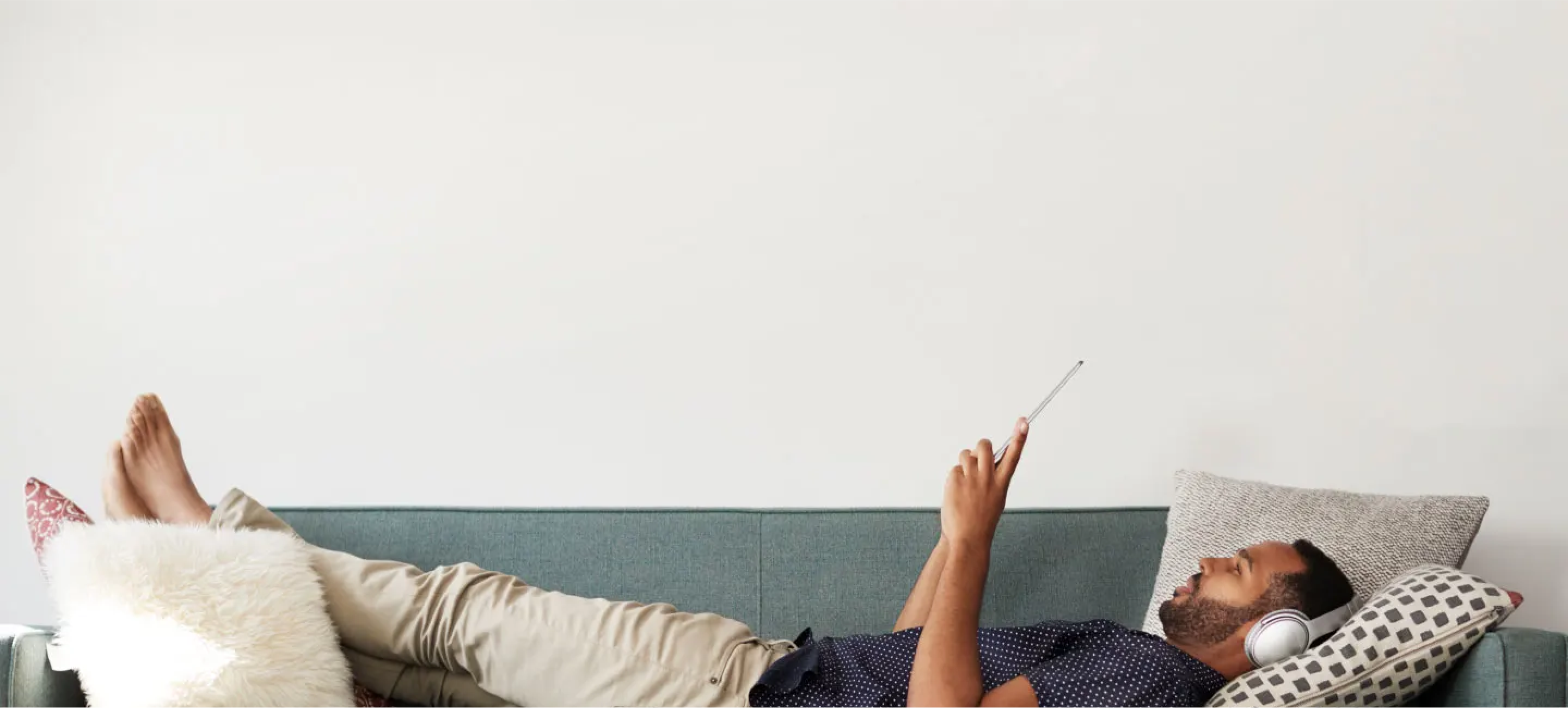 Man laying on couch with device background image