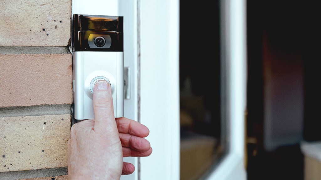 an image of a person ringing a video doorbell