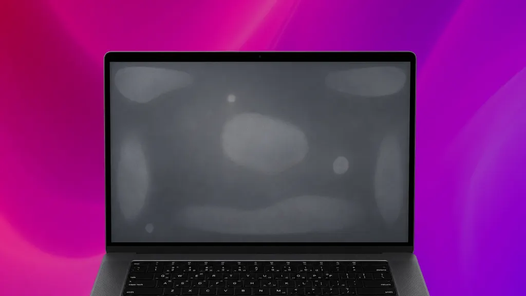 Clos-up of a black laptop screen with pressure patches on the screen