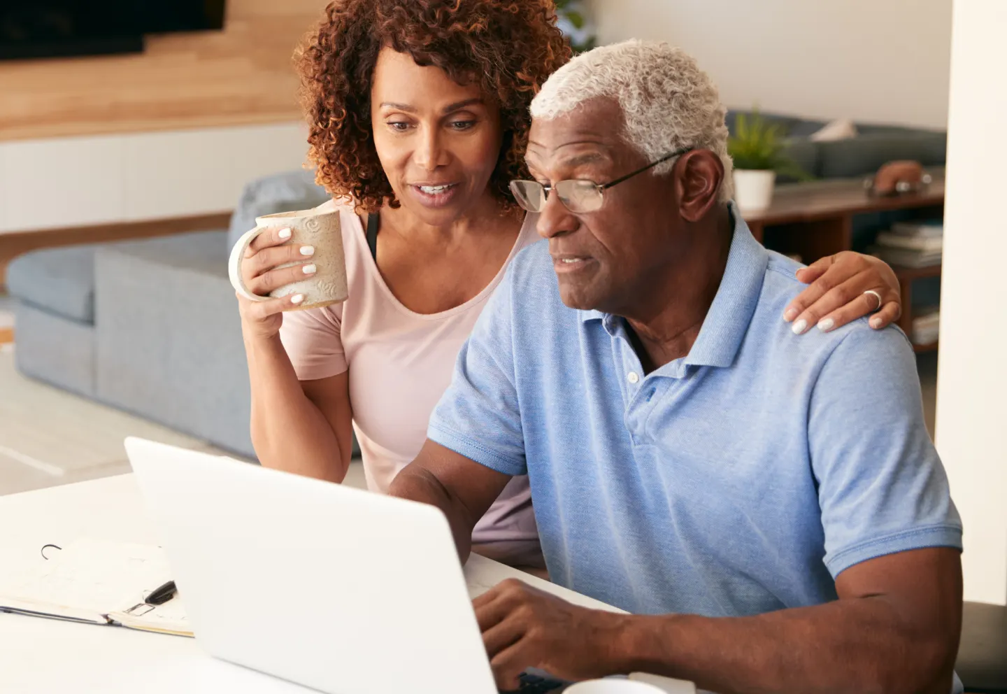 Couple looks at laptop