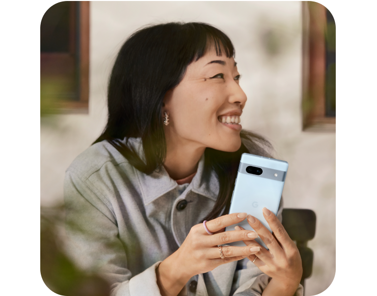 Woman smiling using a google phone