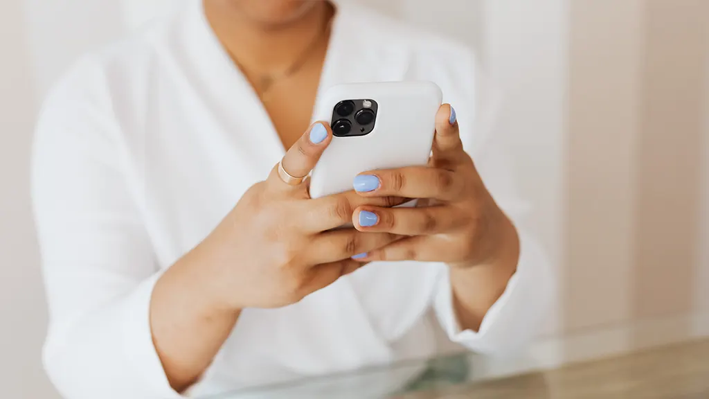 Woman holding iPhone that won't update