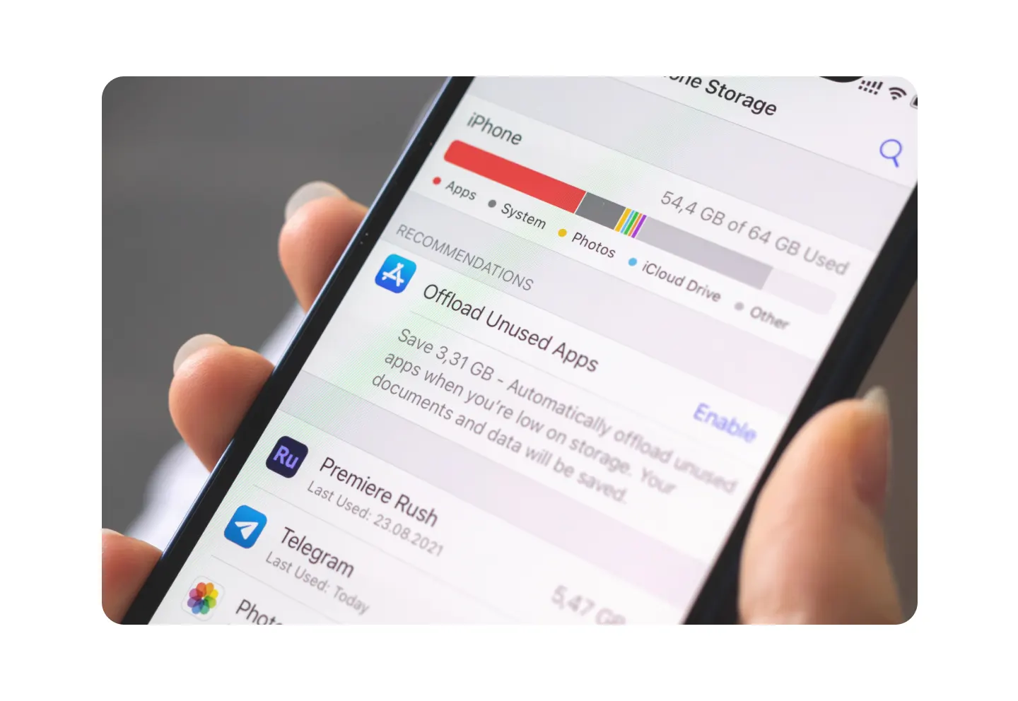 Close-up of iPhone storage settings showing app storage usage and recommendations to offload unused apps and free up space.