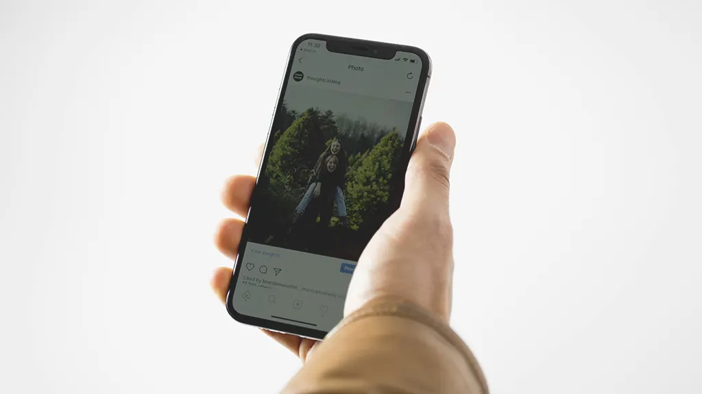 Person holding iPhone with too dark screen