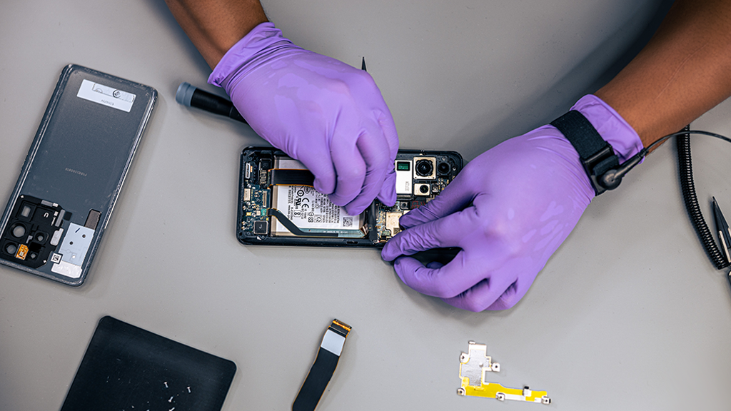 close up of hands repairing a Samsung Galaxy phone