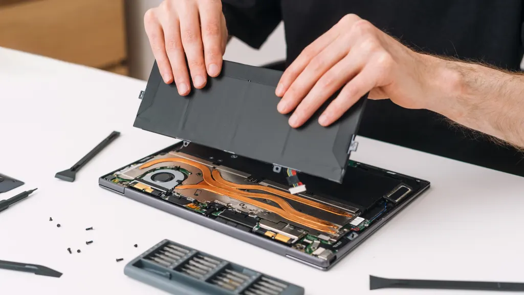 Lifestyle image of person exposing battering on the back of a laptop