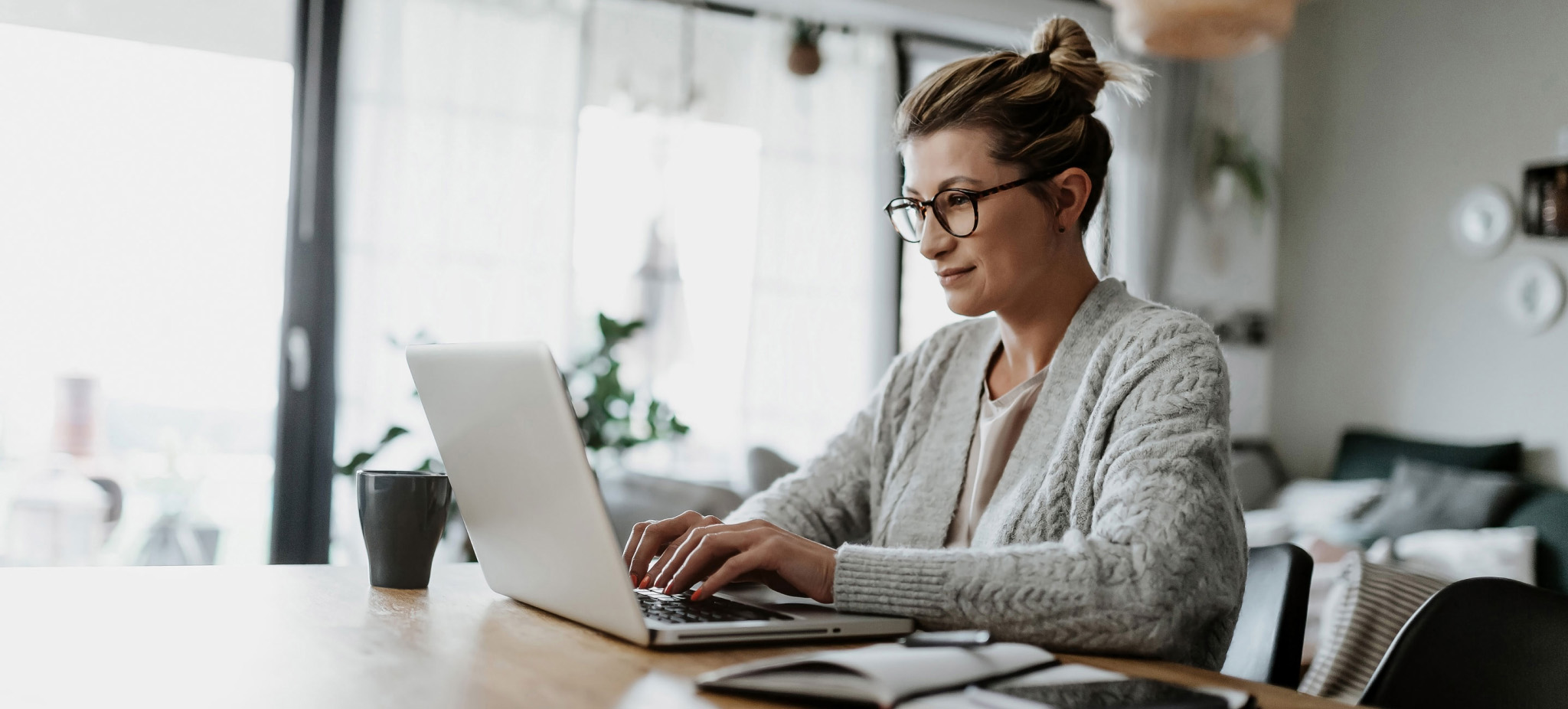 woman typing on laptop at home