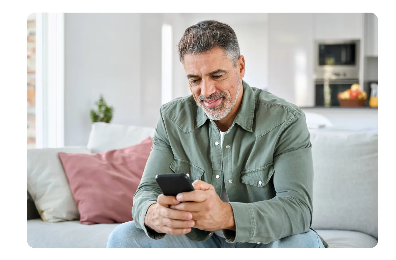 Man on couch using phone