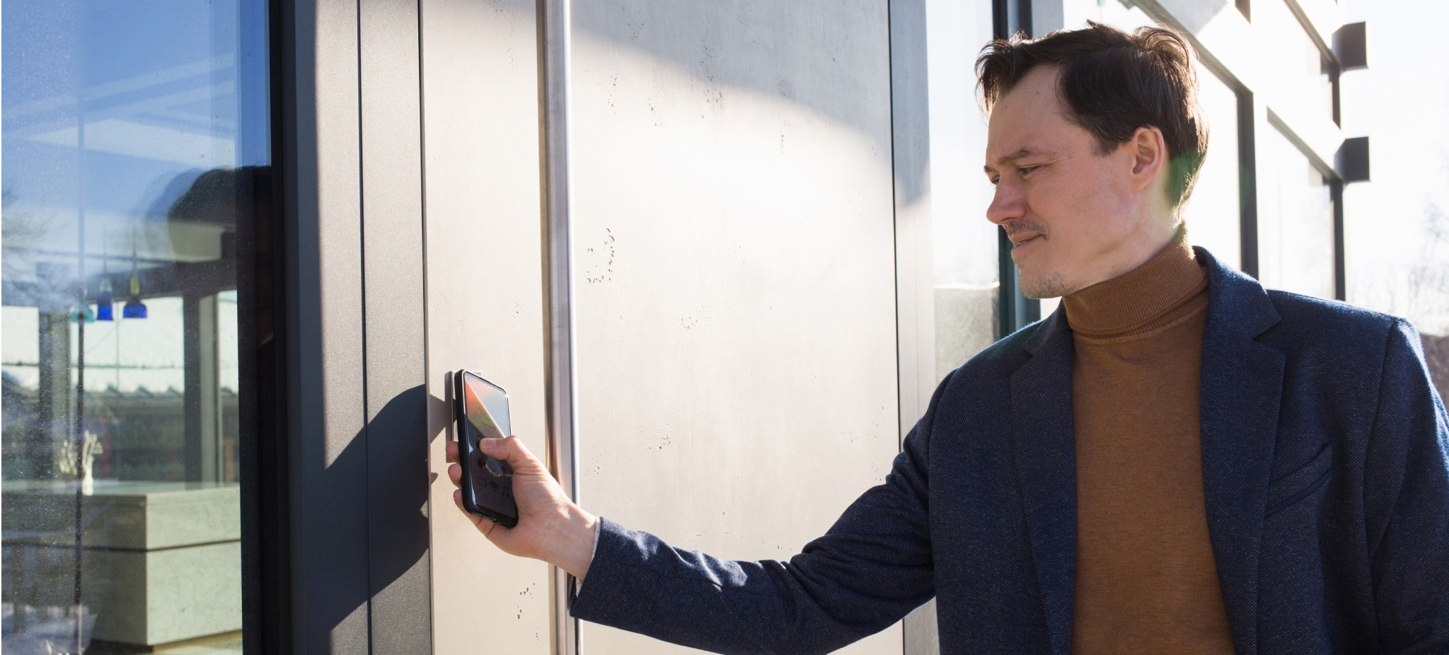 Man using smartphone on smart lock