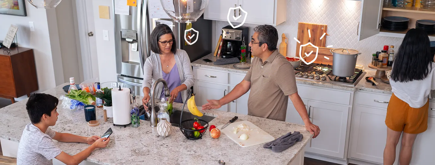 Family in kitchen with appliances covered by Appliance+ protection plan