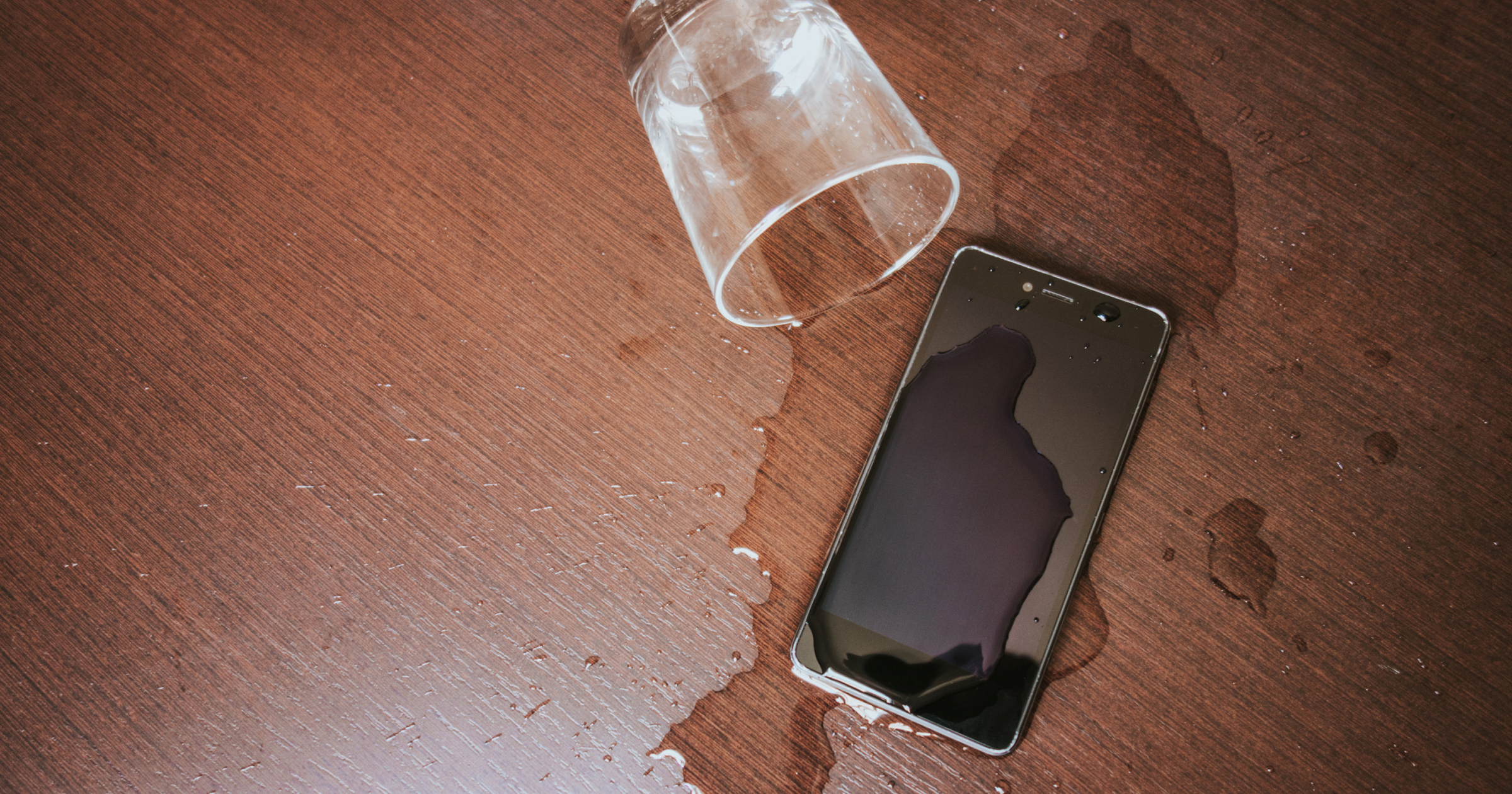 Cup spills water on phone
