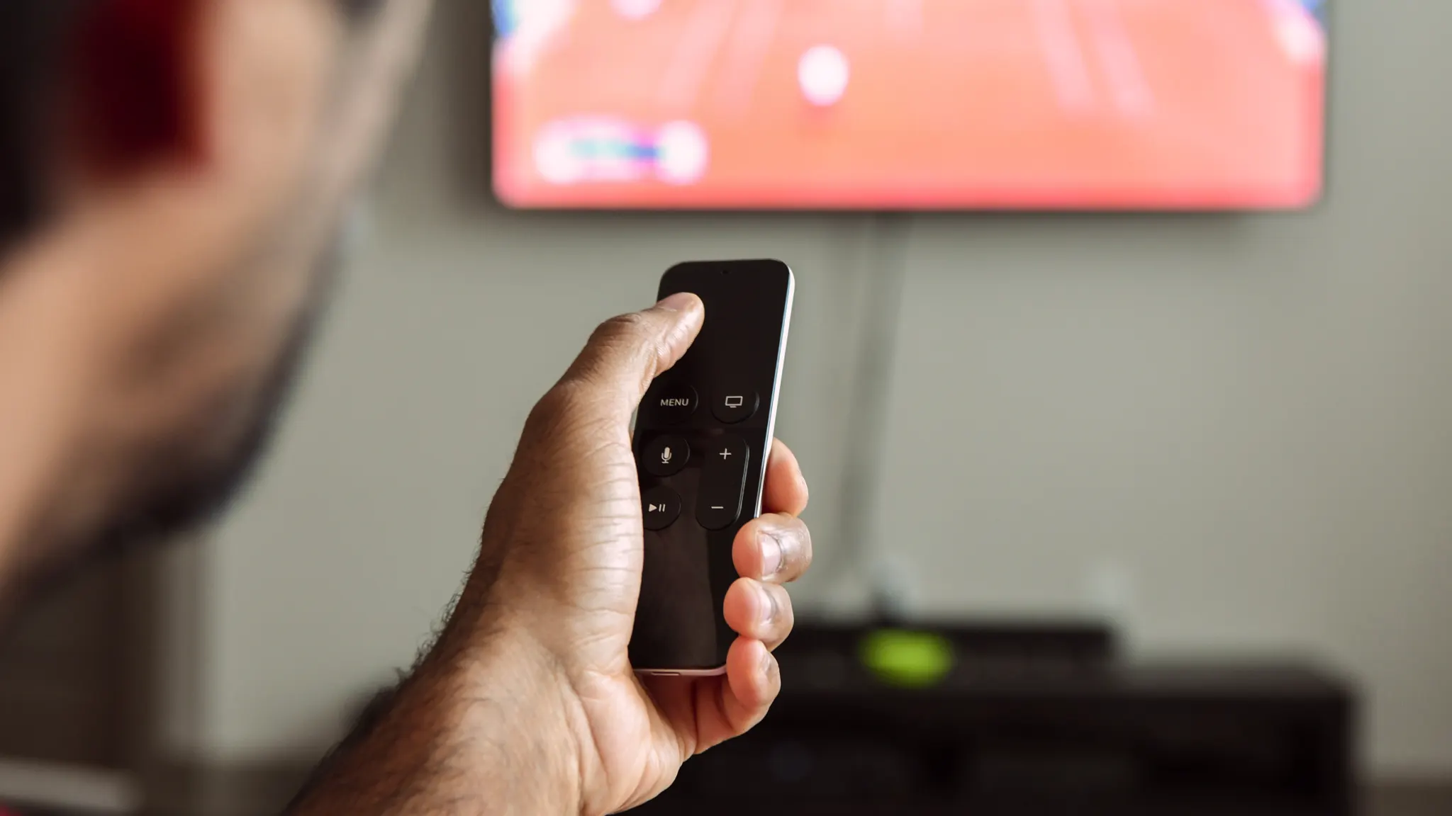 Apple TV with remote, illustrating how to fix app loading issues and restore streaming content