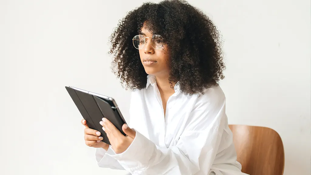 Woman holding iPad that won't hold a charge