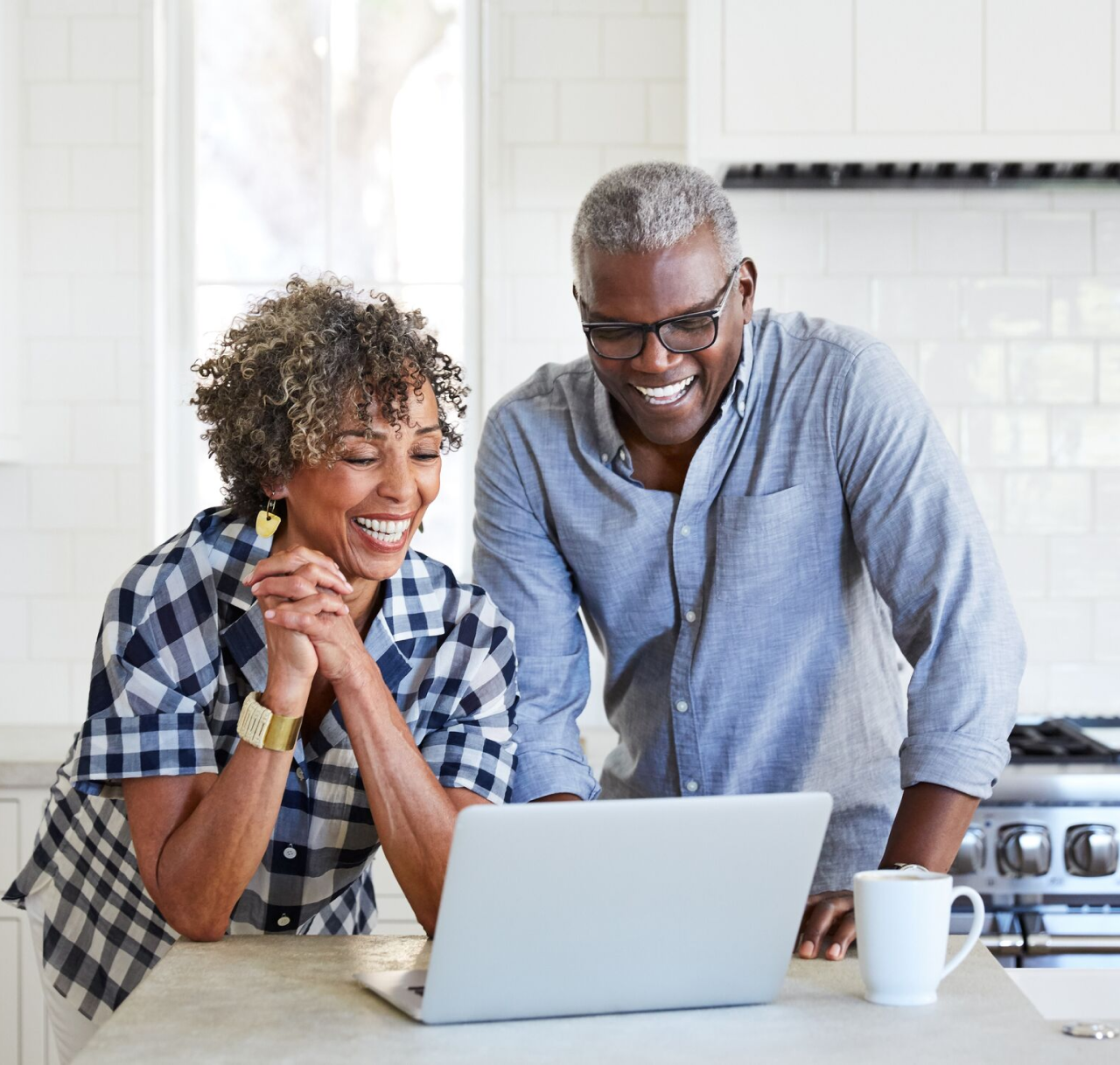 couple with laptop in kitchen