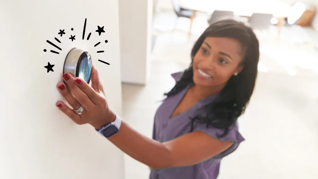 Woman adjusting smart thermostat