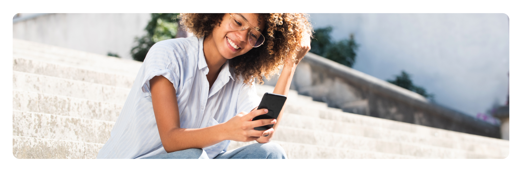 Woman using phone on steps