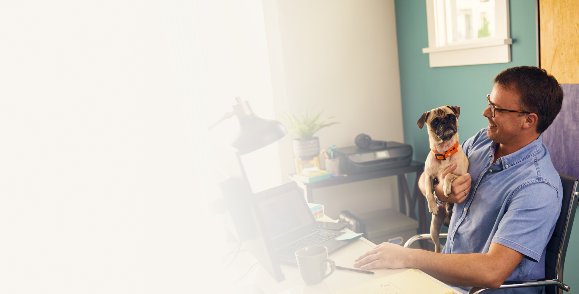 Man working at desk with dog
