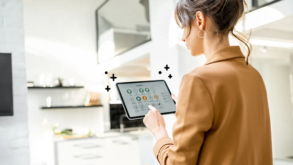 A woman controls her smart home devices using a tablet